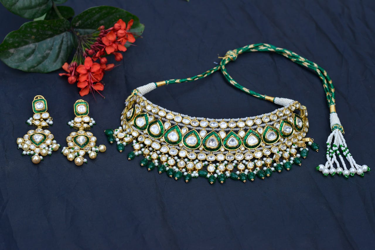 about-us-01 Elegant necklace and earring set with vibrant flowers on a blue background, perfect for festive attire.